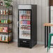 A black refrigerated glass door merchandiser with LED lighting, used for displaying beverages and food items.