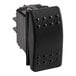 A black plastic Cleveland rocker switch with holes on the sides.