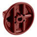 A red plastic control knob for a range with holes in it.