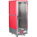 A red and silver Metro C5 heated holding cabinet with a clear door.