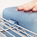 A person using a Rubbermaid ProServe blue ice tote.