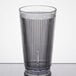 A close-up of a clear Carlisle Crystalon plastic tumbler.