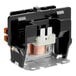A black and silver electrical contactor with a copper wire.