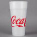 A white Dart foam cup with red Coca-Cola text.