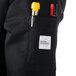 A pocket on a black Mercer Culinary chef jacket.