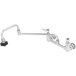 A stainless steel T&S wall mounted pot filler faucet with two handles and a red button.