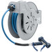 A T&S blue epoxy coated steel hose reel with a hose attached.