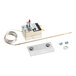 A thermostat capillary kit with a coiled sensor, mounting hardware, and a metal plate.