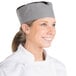 A woman wearing a large Chef Revival houndstooth baker's skull cap with black and white checkered fabric.