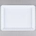 A white rectangular tray with scalloped edges.