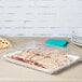A white Fineline plastic rectangular tray with food in it.