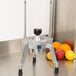 A Vollrath Redco Wedgemaster wedging an apple and oranges on a metal surface.