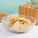 A Cambro pebbled serving bowl filled with chips on a table.