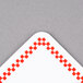 A white square Ketchum Manufacturing deli tag with a red checkered border.