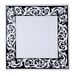 A close up of a black and white square plate with a decorative design.