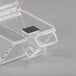 a clear plastic container with a black square on top