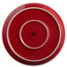 A red Tuxton pizza serving plate with a white rim.