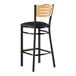 A Lancaster Table & Seating black wood bar stool with a black cushioned seat.