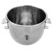 A silver stainless steel bowl with a handle.