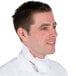 A man in a white chef coat wearing a white Intedge chef neckerchief.