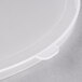 A close-up of a clear plastic lid with a small hole.