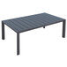 A Grosfillex Volcanic Black aluminum rectangular cocktail table with slats on a patio.