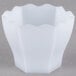 A close-up of a white Fineline hexagon cube bowl.