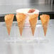 A row of ice cream cones in a Choice 4 hole acrylic cone holder.