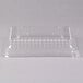 A clear plastic Fineline Flairware serving tray dome lid on a clear plastic tray.