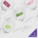 A group of customizable SAN plastic wine glasses with a logo.