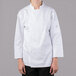 A woman wearing a white Mercer Culinary chef jacket.