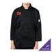 A person wearing a black Mercer Culinary chef coat.