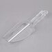 A Cambro clear plastic scoop with a handle on a gray surface.
