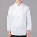 A woman wearing a white Mercer Culinary chef jacket.