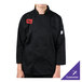A person wearing a Mercer Culinary black chef coat.