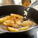 Light brown sugar sprinkled on top of food in a skillet.