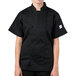 A woman wearing a Mercer Culinary black chef coat.