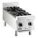 A stainless steel countertop range with two gas burners and control knobs.