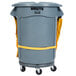 A Rubbermaid grey trash can with yellow straps.