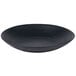 A black stoneware pasta plate with a wavy texture.