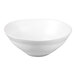 A large white stoneware serving bowl with a matte finish and a wavy rim.