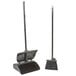 A Carlisle Duo-Sweep lobby broom and dustpan set with long handle.