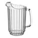 A clear plastic pitcher with a handle.