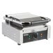 A Galaxy stainless steel Panini grill with a black handle.