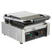 A Galaxy stainless steel commercial panini sandwich grill with grooved top and smooth bottom plates and a handle.