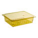 A yellow Cambro plastic colander pan with holes in it.