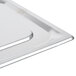 A Vollrath stainless steel 1/2 size steam table pan cover on a metal tray.