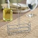 A metal wire rack designed to hold a 6 oz. olive oil cruet.