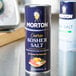 A can of Morton Coarse Kosher Salt on a counter.