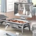 Acopa Voyage chafer stand with fuel holders on a table with white plates and a spoon inside.